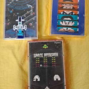 Three Tomy Pocket Games.
