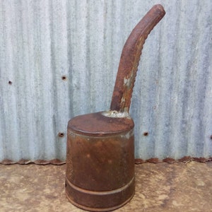 vintage Huffman oil dispenser from Dayton, Ohio. Has 7 inch spout with sharp opener and spout inside.