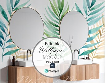 May include: A bathroom mockup featuring two round mirrors with a gold trim, above wooden cabinets with white sinks and black faucets. The wallpaper has a watercolor design of green and blue leaves. The image includes the text "Editable Wallpaper Mockup".