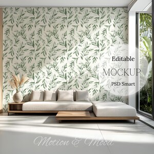 May include: A white couch with light brown wooden legs sits in a room with a white wall featuring a green leaf pattern wallpaper. The room has a large window with a view of green foliage. The text "Editable MOCKUP PSD Smart" is visible in the image.