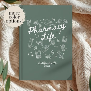 May include: A sage green hardcover journal featuring the white text Pharmacy Life, surrounded by line art illustrations of pill bottles, syringes, and Rx symbols. The name Caitlyn Smith and the title CPHT are printed in white at the bottom.
