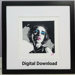 May include: Framed art print featuring a stylized portrait of a person with blue eyeshadow and pink lipstick. The artwork is primarily black and white with pops of color. The print is matted and framed in a black frame. The words "Digital Download" are at the bottom.