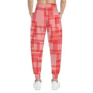 May include: Red and pink sweatpants with a geometric pattern of squares and rectangles.