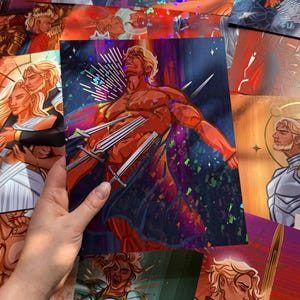 May include: An art print featuring a muscular figure with swords piercing their chest, set against a dark, starry background. The figure has blond hair and is depicted in shades of red and orange. Other art prints are visible in the background.