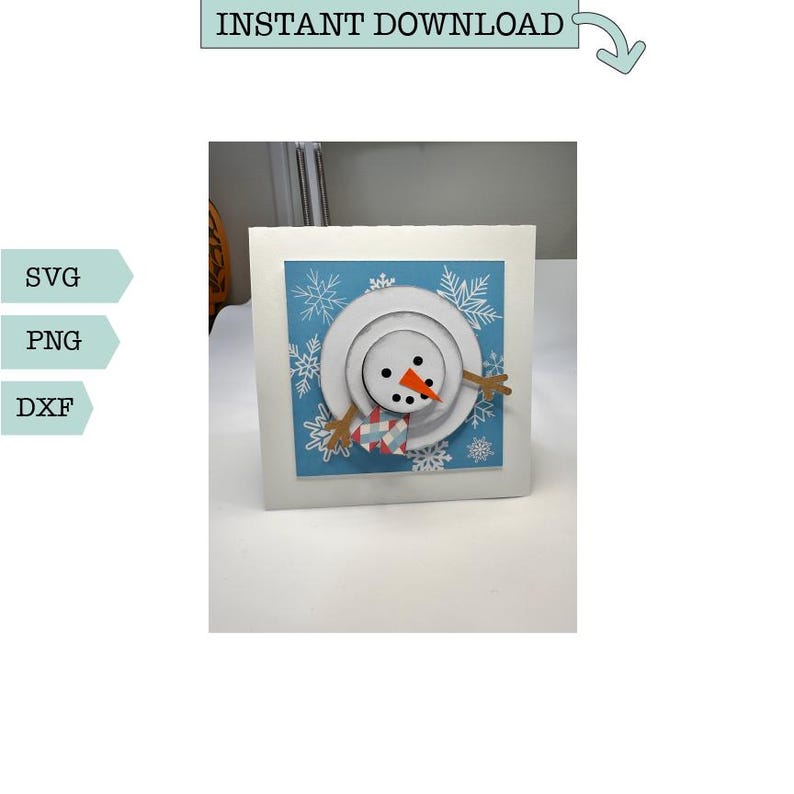 May include: A white card with a blue background and a snowman face made of paper circles. The snowman has a red nose, black eyes, and a striped scarf. The background is decorated with white snowflakes.