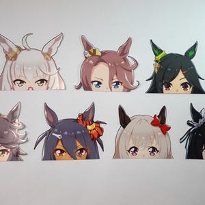 May include: A collection of eight anime-style stickers featuring stylized character faces with various hair colors and accessories. Each sticker has a unique design, with visible eyes and partial hairstyles.