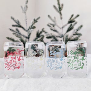 May include: Four clear glass cups with the text "I Solemnly Swear That I Am Up To No Good" printed on them in different colors. The cups are sitting on a white surface.