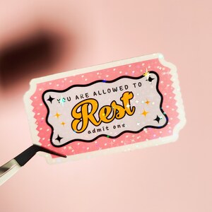 May include: Pink ticket with white polka dots and a glittery finish. The ticket says "You are allowed to Rest, admit one".