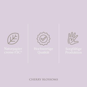 May include: Three icons on a light purple background. The first icon is a leaf, the second is a checkmark inside a circle, and the third is a hand with a heart inside. The text below the icons reads "Naturpapier creme FSC&reg;, Hochwertige Qualit&auml;t, Sorgf&auml;ltige Produktion" and "CHERRY BLOSSOMS".