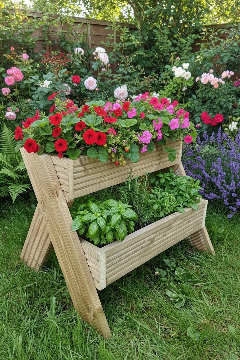 May include: A two-tiered wooden planter filled with vibrant red and pink flowers and green herbs. The planter is set in a lush garden with a backdrop of colorful roses and greenery, creating a natural aesthetic.