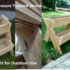 May include: A two-tiered wooden planter, constructed from pressure-treated wood, designed for outdoor use. The planter features a rectangular shape with slatted sides and is supported by angled legs. The text "Pressure Treated Wood" and "Built for Outdoor Use" are visible.