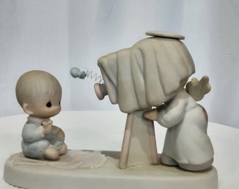 Precious Moments "Baby's First Picture" porcelain bisque figurine