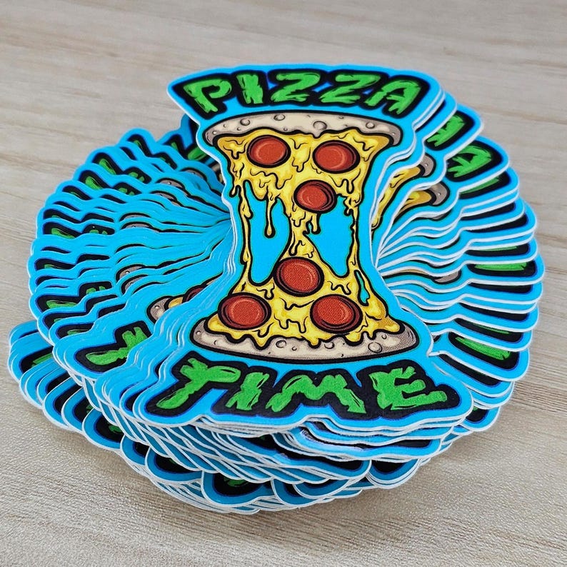 May include: A stack of die-cut stickers featuring a slice of pizza with melting yellow cheese and red pepperoni. The text PIZZA is printed in green at the top and TIME is printed in green at the bottom, all set against a bright blue background.