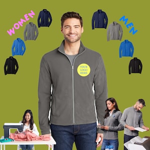 May include: A gray fleece jacket with a zipper closure and a yellow circle on the left chest that says "YOUR LOGO HERE". The jacket is shown on a model wearing blue jeans. There are multiple jackets in different colors shown around the model.