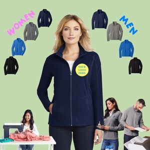 May include: A navy blue fleece jacket with a zipper closure and a yellow circle with the text "YOUR LOGO HERE" on the left chest. The jacket is shown on a model with a variety of other jackets in different colors in the background.
