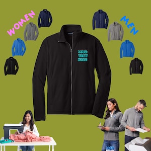 May include: A black fleece jacket with a zipper closure and a blue embroidered text that says "YOUR TEXT HERE".