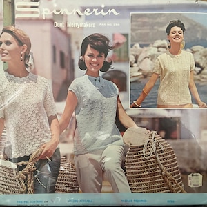 May include: A vintage knitting pattern packet for a women's top, featuring two models wearing the finished garment. The pattern is called "Spinnerin Duet Merrymakers" and the packet number is 200.