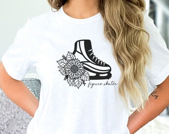 May include: White t-shirt with a black graphic of a figure skate with a floral design and the text "figure skater".