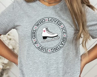 May include: A gray t-shirt with a black circle graphic that says "Just a girl who loves ice skating" with a white ice skate and a pink heart.