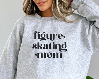 May include: Gray sweatshirt with the text "figure skating mom" in black.