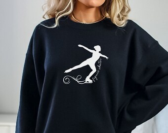 May include: Black sweatshirt with a white silhouette of a figure skater and the text "figure skater" on the front.