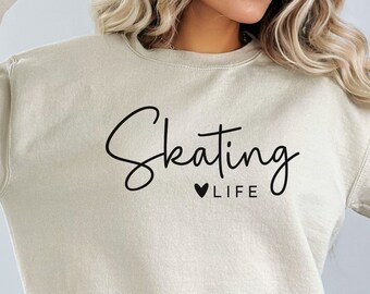 May include: A light beige sweatshirt with the text "Skating ♥ LIFE" printed in black.