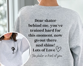 May include: Gray sweatshirt with a black graphic of a figure skater and the text "Dear skater behind me, you've trained hard for this moment, now go out there and shine! Lots of Love - The skater in front of you".