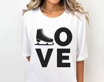 May include: White t-shirt with a black graphic of an ice skate and the word "LOVE" printed on it.