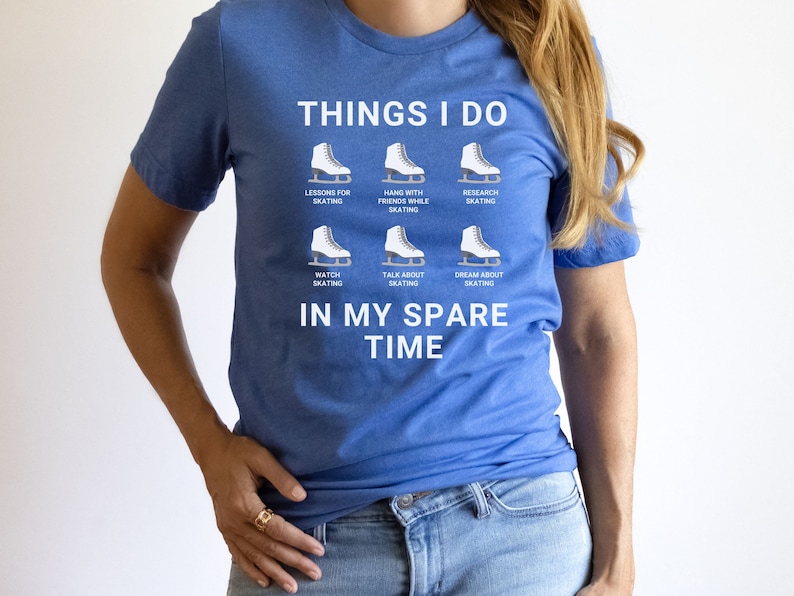 May include: A blue t-shirt with white text that reads "Things I do" and lists activities related to ice skating. The text includes "Lessons for skating", "Hang with friends while skating", "Research skating", "Watch skating", "Talk about skating", and "Dream about skating". The text concludes with "In my spare time".