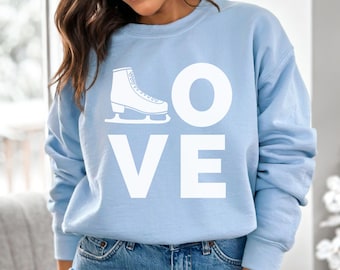 May include: A light blue sweatshirt with the word "LOVE" printed in white. The "O" is replaced with a white outline of an ice skate.