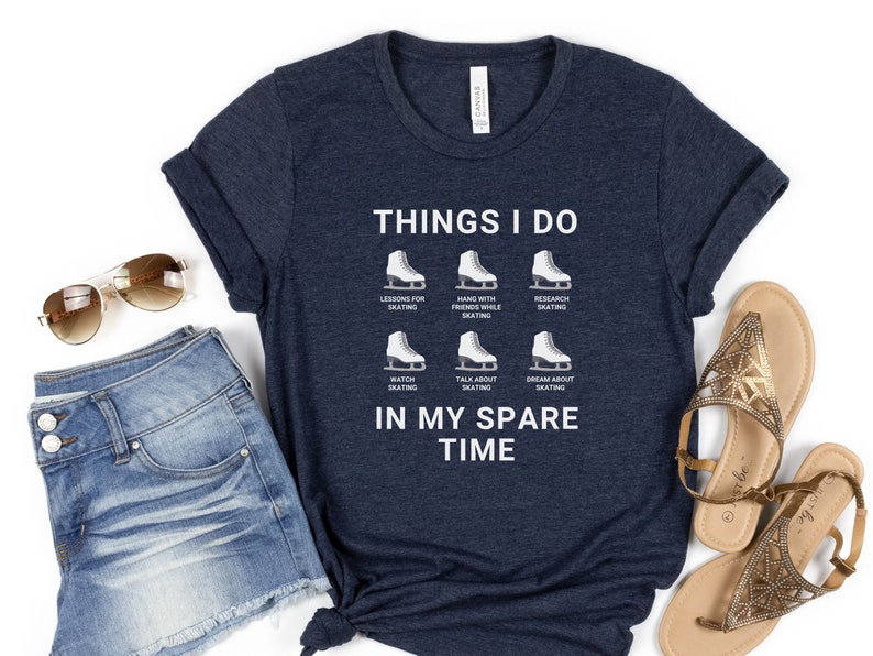 May include: A navy blue t-shirt with white text that reads "Things I do" and lists activities related to ice skating. The text "In my spare time" is also printed on the shirt.