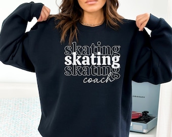 May include: Black sweatshirt with white text that reads "skating skating skating coach" in a stacked, layered font.