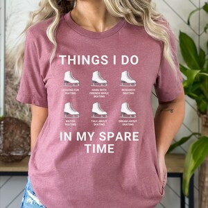 May include: A mauve t-shirt with the text "THINGS I DO" and a series of ice skate graphics with text describing activities related to ice skating. The text "IN MY SPARE TIME" is below the graphics.
