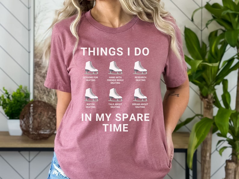May include: A mauve t-shirt with the text "THINGS I DO" and a series of ice skate graphics with text describing activities related to ice skating. The text "IN MY SPARE TIME" is below the graphics.