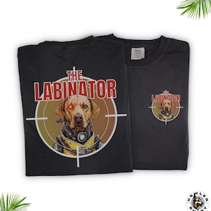 May include: Black t-shirt with a graphic of a dog wearing a futuristic helmet and the text "The Labinator" in red and white. The dog has one red eye. The graphic is inside a target symbol.