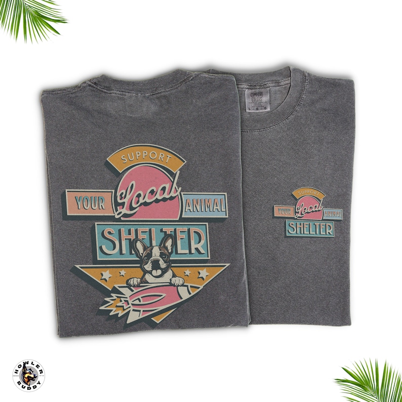 May include: Two charcoal gray t-shirts with a graphic supporting local animal shelters. The design features a French bulldog on a rocket, with text reading "Support Your Local Animal Shelter" in a retro style.