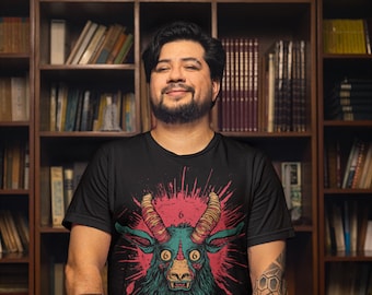 May include: A person wearing a black t-shirt with a graphic of a green and red goat head with the number 666 on its forehead. The goat head is surrounded by red and pink splatter paint. The person is holding two black knives with white handles.
