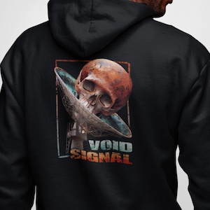 May include: Black hoodie with a graphic of a skull inside a satellite dish. The text "VOID SIGNAL" is printed below the image.