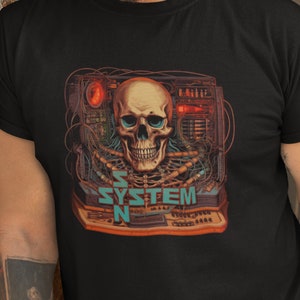 May include: A black t-shirt featuring a graphic print of a skull inside a computer system with wires and the text "SYSTEM N".