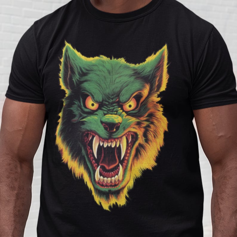 May include: Black t-shirt with a green and yellow wolf graphic. The wolf has a menacing expression with sharp teeth and glowing eyes.