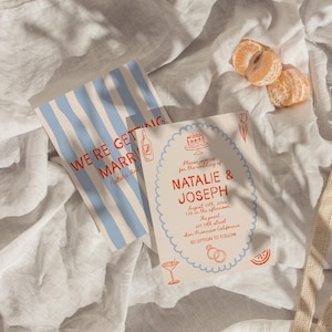 May include: Wedding invitation suite featuring two cards and a reusable net bag. One card has blue stripes and the text "WE'RE GETTING MARRIED". The other card has the names "NATALIE & JOSEPH" and wedding details. Two orange mandarin orange segments are also visible.
