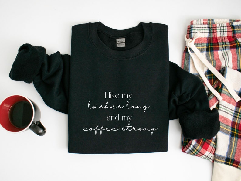 May include: Black sweatshirt with white text that reads "I like my lashes long and my coffee strong".