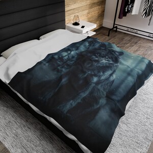 May include: A dark blue and grey wolf blanket with a white background. The wolf is sitting in a woodland setting with a blurred background.