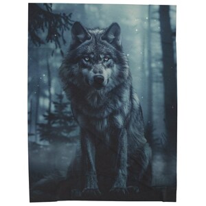 May include: A gray wolf sits in a misty forest setting. The wolf has a serious expression and its fur is a mix of gray and black. The background is a blurry blue and green.