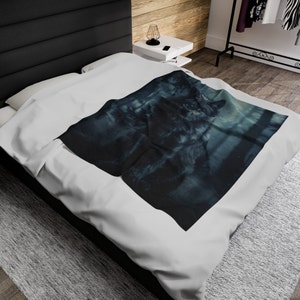 May include: A black and white wolf blanket with a blue and white background. The wolf is looking to the right and is in a snowy forest setting.