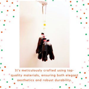 May include: A group of five dark brown glass bottles are hanging from a pair of tongs. The bottles are suspended against a white background. It's meticulously crafted using top-quality materials, ensuring both elegant aesthetics and robust durability.