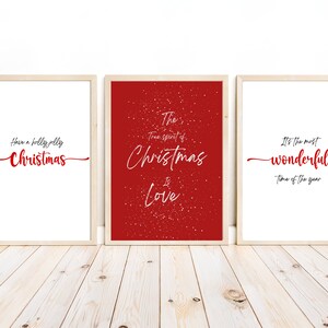 May include: Three framed prints with red text on a white background. The first print says "Have a holly jolly Christmas". The second print says "The true spirit of Christmas is Love". The third print says "It's the most wonderful time of the year".