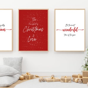 May include: Three framed prints with Christmas-themed quotes. The first print has a red background with white snowflakes and the text "The true spirit of Christmas is Love". The second print has a white background with the text "Have a holly jolly Christmas". The third print has a white background with the text "It's the most wonderful time of the year".