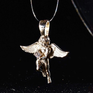 A delicate silver angel necklace with a sparkling CZ solitaire and gold-plated cherub charm — handmade remembrance jewelry for baby loss, baptism, or spiritual gifting.