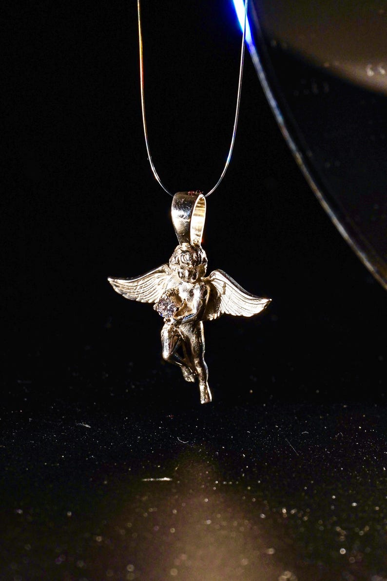 A delicate silver angel necklace with a sparkling CZ solitaire and gold-plated cherub charm — handmade remembrance jewelry for baby loss, baptism, or spiritual gifting.